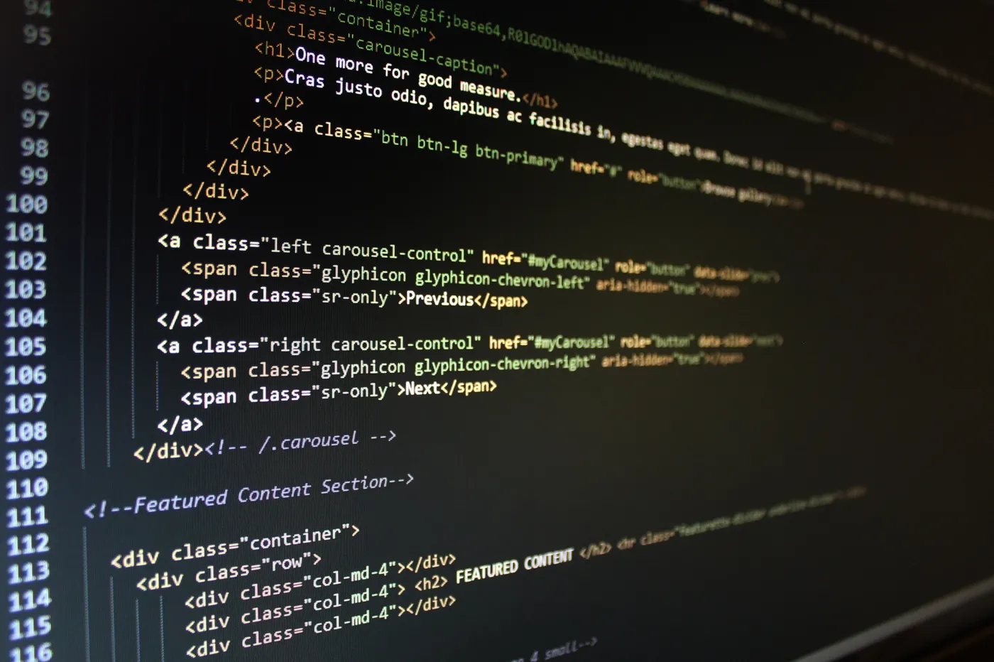 Close-up of HTML code displayed on a computer monitor, showcasing web development.